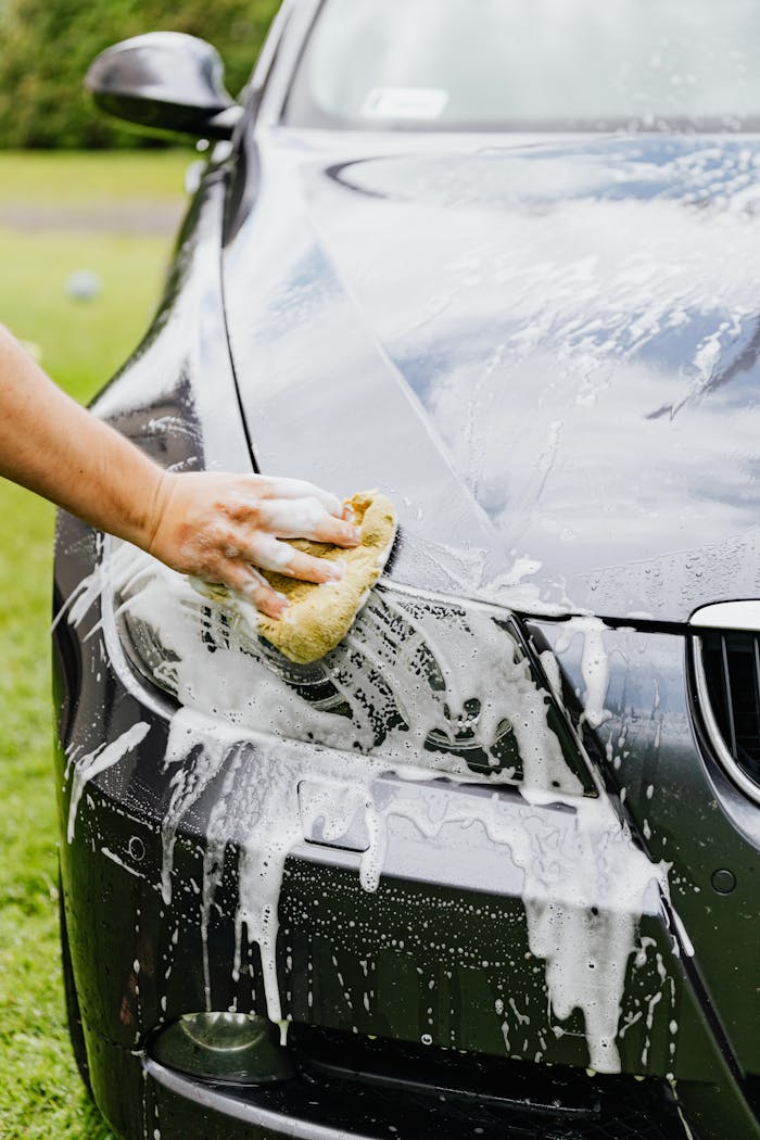 Person cleaning a Black Car